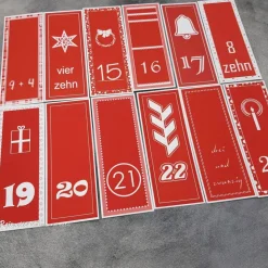 Adventskalendertüten und Zahlenanhänger in rot-weiß