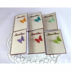 Dankekarte mit Hintergrundprägung und Schmetterling