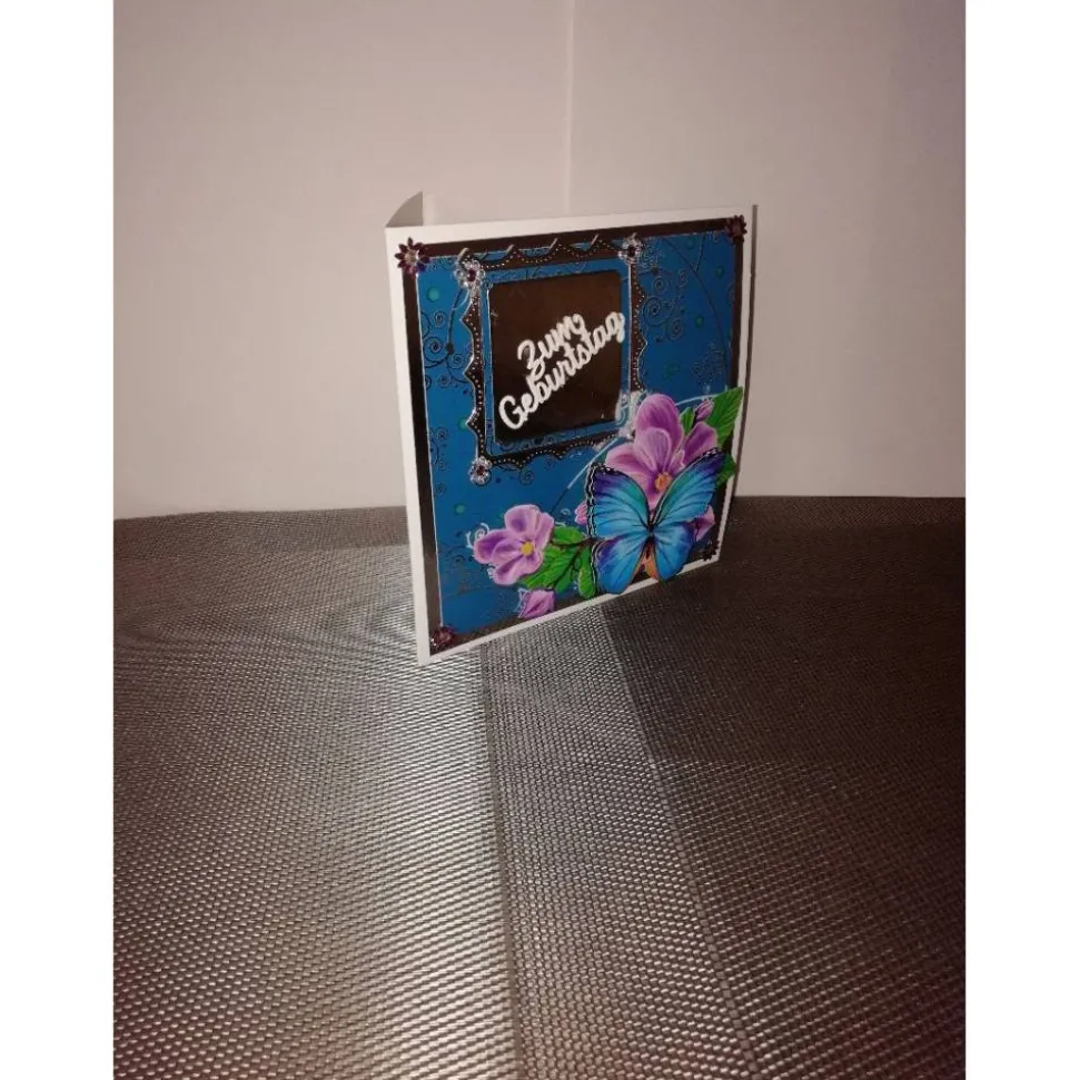 Geburtstagskarte für eine Frau in türkis, silber mit einem blauen Schmetterling