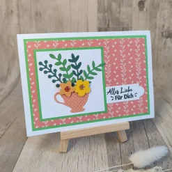 Glückwunschkarte mit Blättern und Blumen