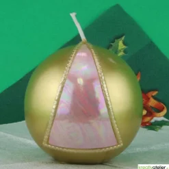 Goldene Weihnachtskerze mit rosafarbigem Dreieck