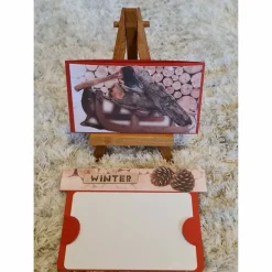 Gutscheinverpackung " Winter " Tannenzapfen , Schlitten , Holz , Axt