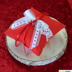 Handgefertigtes Ringkissen aus rotem Poppeline mit liebevoll angebrachter weißer Klöppelspitze und edlen Satinbändern