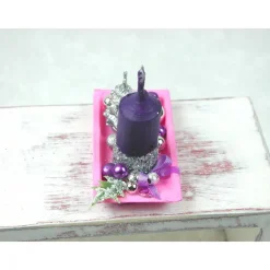 Rechteckige rosa Kunststoffplatte mit hochgebogenen Seiten mit violetter Kerze in weihnachtlicher  Dekoration