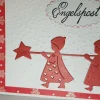 Rote Engel bringen die Weihnachts-Karte mit Weihnachts-Grüßen Handmade