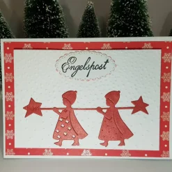 Rote Engel bringen die Weihnachts-Karte mit Weihnachts-Grüßen Handmade