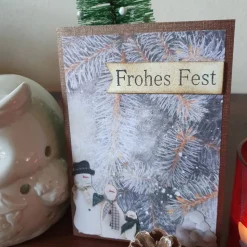 Weihnachtskarte Frohes Fest mit Schneemann und Zweigen