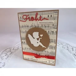 Weihnachtskarte mit Notenpapier, Himmelsbote und Satinband