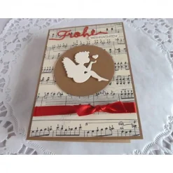 Weihnachtskarte mit Notenpapier, Himmelsbote und Satinband
