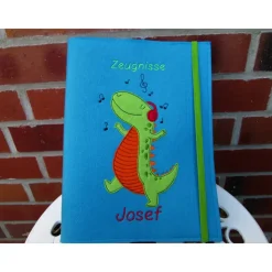 Zeugnissmappe / Zeugnisshülle aus Filz "Dino hört Musik"
